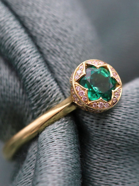 Tesoro ring with a Zambian emerald and diamond-set engraved 14ct yellow gold on a grey fern leaf