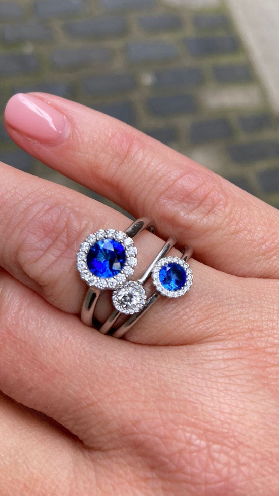 Two sapphire and one diamond Cannele British Engagement RIngs worn by Katerina