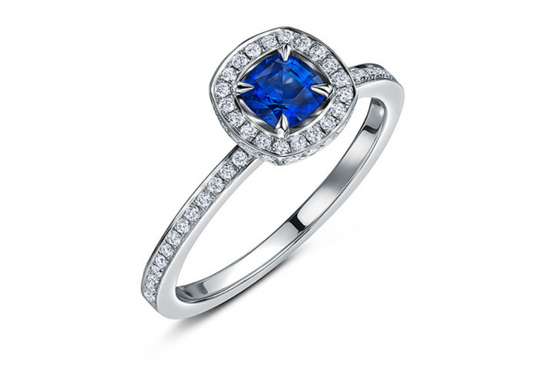 Daniel Cross sapphire radiant bespoke British engagement ring by Andrew Geoghegan with a stunning blue gemstone