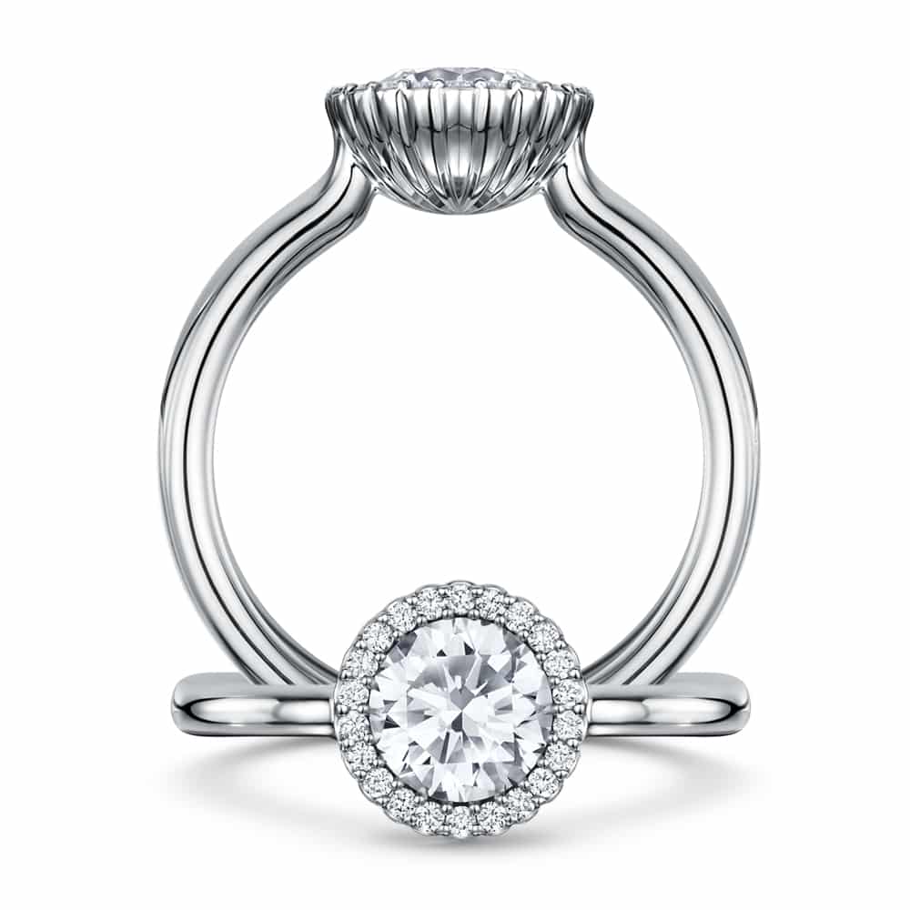 Cannelé platinum diamond halo ring seen from a three quarter angle, showing the fluted crown