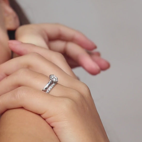 Chapiteau de Diamants hexagon halo engagement ring by Andrew Geoghegan, shown with its matching wedding band