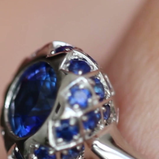 Asteria sapphire halo engagement ring by Andrew Geoghegan, with a brief view of the Asteria diamond halo