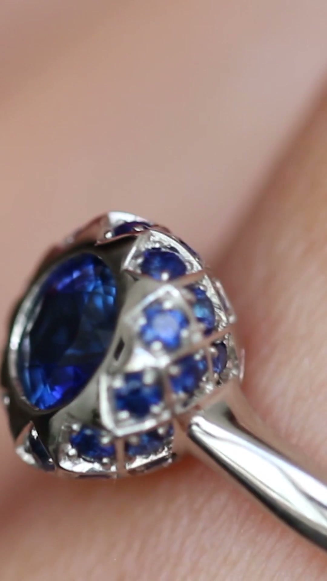 Asteria sapphire halo engagement ring by Andrew Geoghegan, with a brief view of the Asteria diamond halo